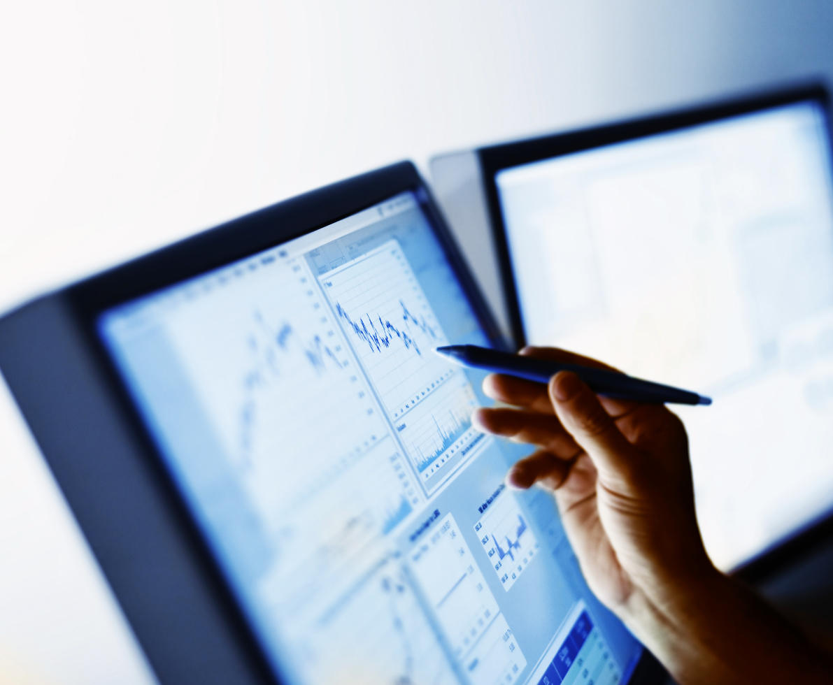 Hand pointing to digital stock market chart